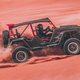 A photo of the Brabus Crawler racing over sand.
